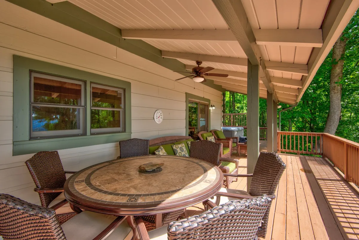 A round outdoor dining table with comfortable seating set amidst lush greenery, perfect for alfresco meals and morning coffee. The arrangement suggests a welcoming spot for family gatherings or celebrating special occasions.